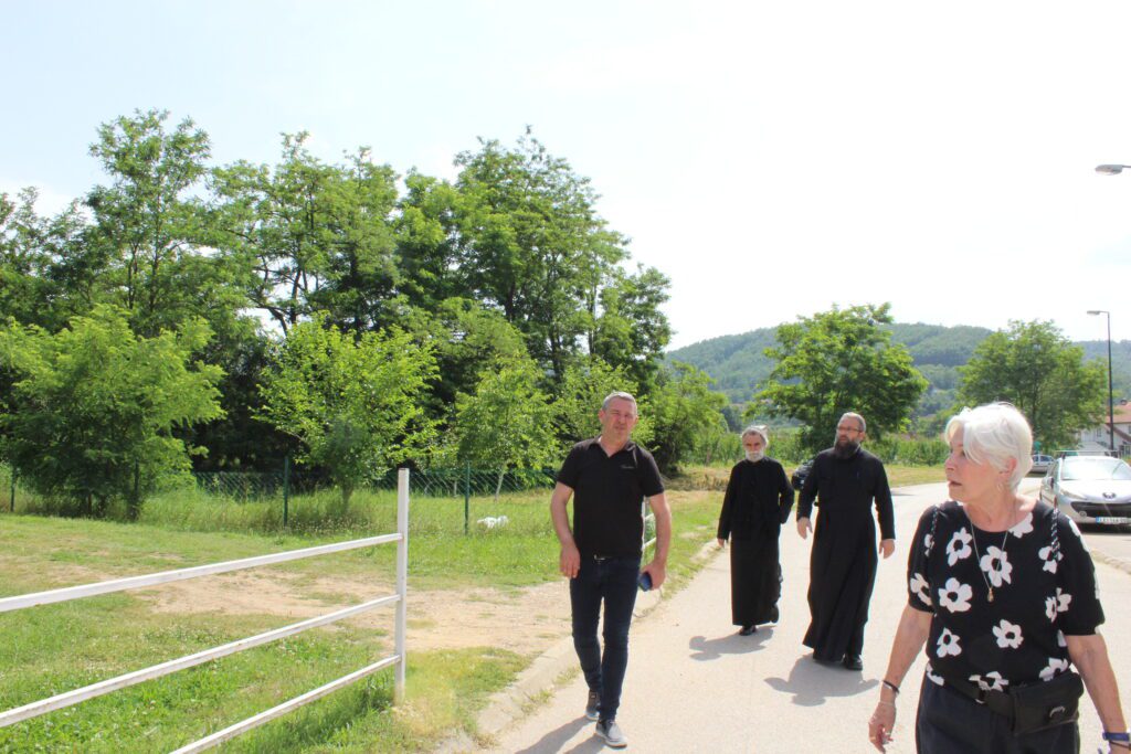 People walking on a path near trees.
