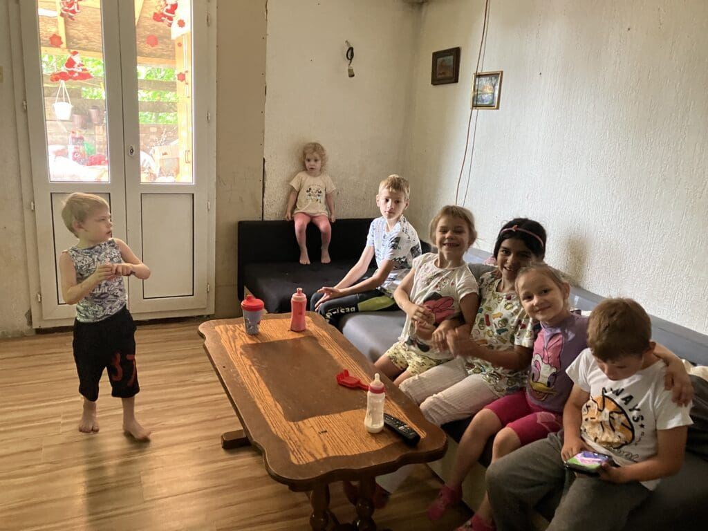 Group of children sitting on couch by table