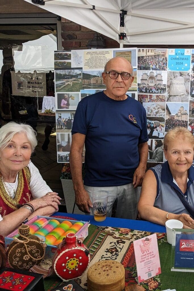 People at a cultural booth with crafts.