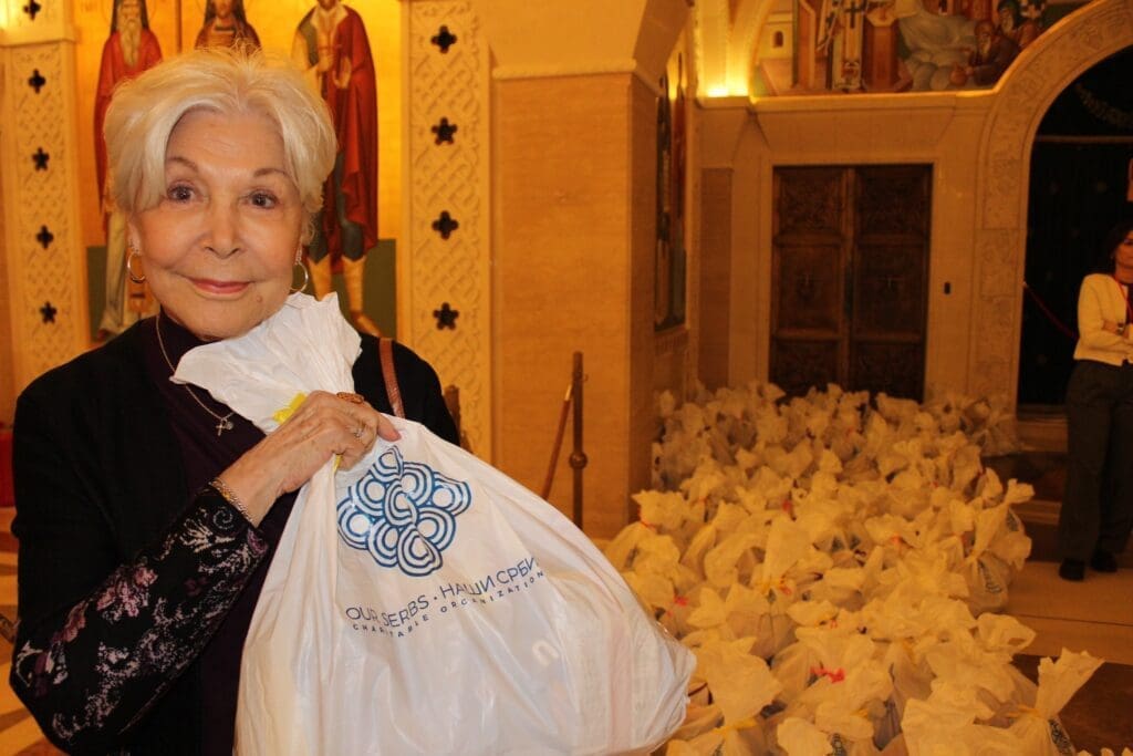 Senior woman holding donation bag in church
