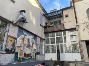 Courtyard with religious mural and glass doors