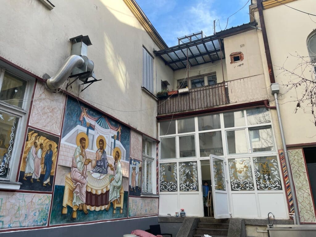 Courtyard with religious mural and glass doors