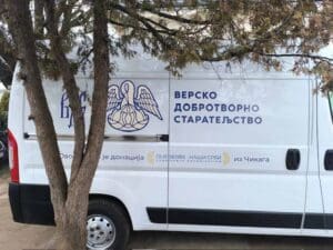 White van with Cyrillic text and logo.