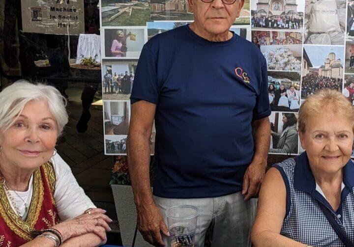 People at a cultural booth with crafts.