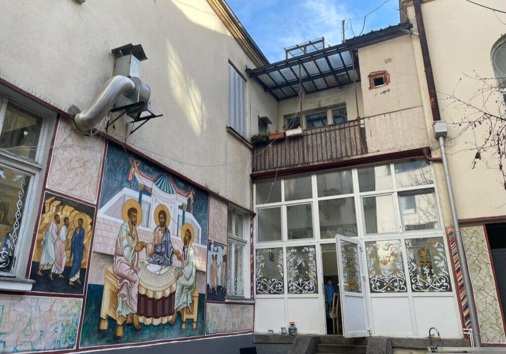 Courtyard with religious mural and glass doors