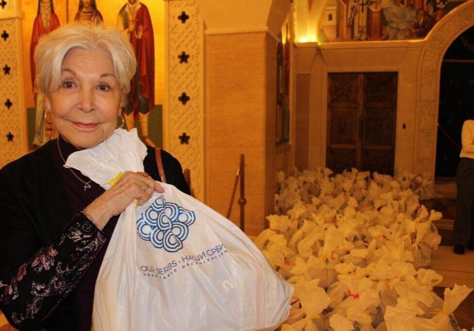 Senior woman holding donation bag in church