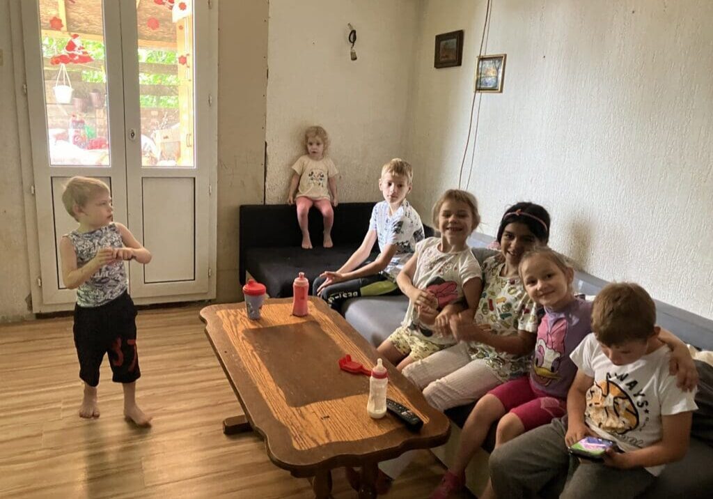 Group of children sitting on couch by table