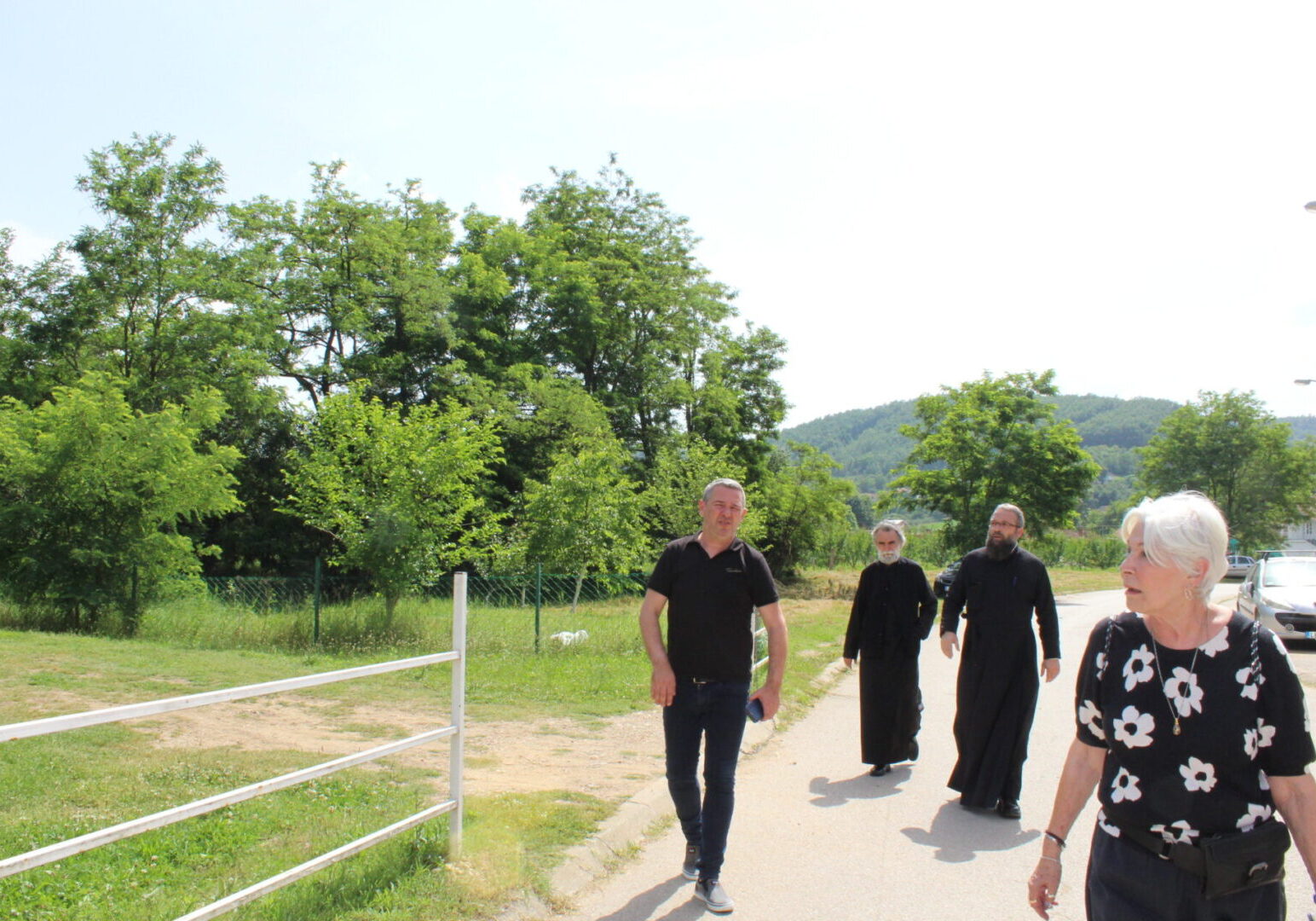 People walking on a path near trees.
